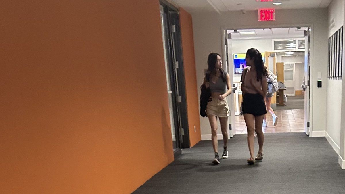 NEW YEAR NEW US. Annie Bai and Amalia Laguna walk past the blank college counseling board. The board brimmed with personality in the spring. Now, bare of colorful posters and college pennants, it begs to be filled for the new year.