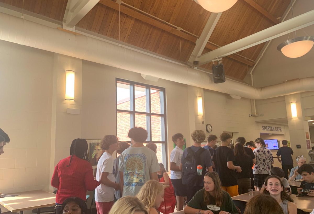 BUSY KITCHEN. As early lunch comes to a close, students file in a line to clean off their plates and get ready to go to class. Its a busy day for the kitchen staff, piles of plates accumulating at the counter.