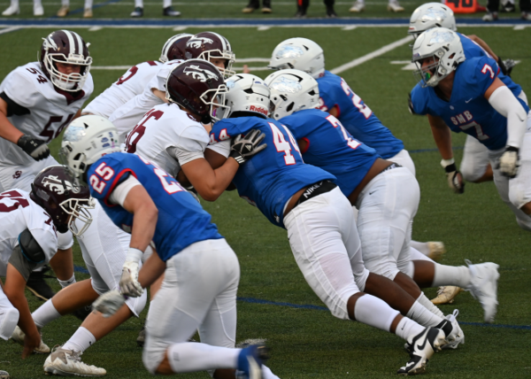 HERE WE COME. Both teams charge at each other either trying to make their way through or stop the other team from moving forward.