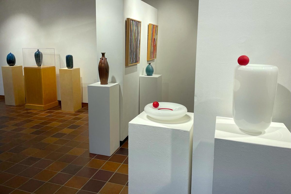 On display are a collection of glass blown sculptures, canvas paintings, elaborate pottery, sustainable clothing designs, and sports uniforms.