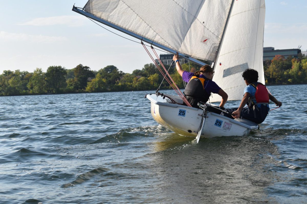 TACK AND JIBE. Leif Rush and Adi Narayan lean towards the water to keep the boat steady during a steering drill.  “Practicing helps us go faster,” Rush said. 