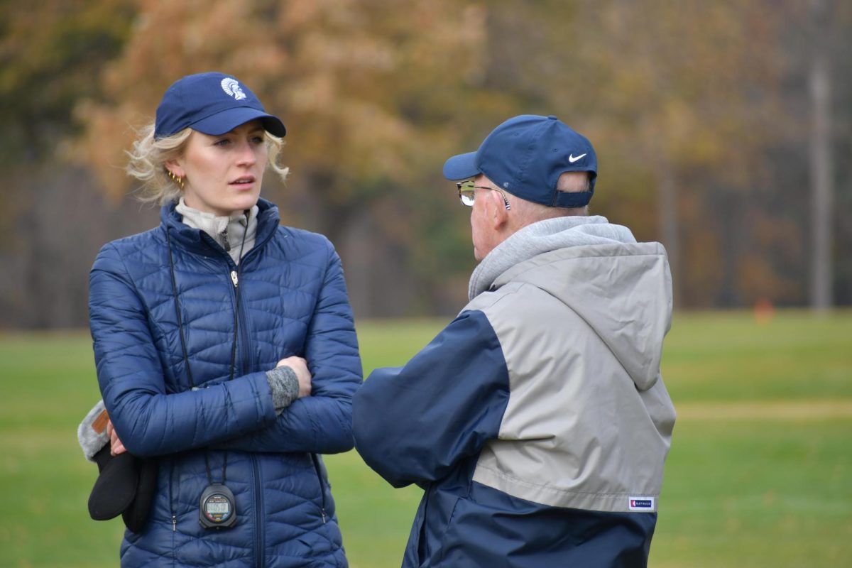 COACH TO COACH. Schmitz converses with fellow coach Robert Donnelly.


Submitted by Sophie Schmitz