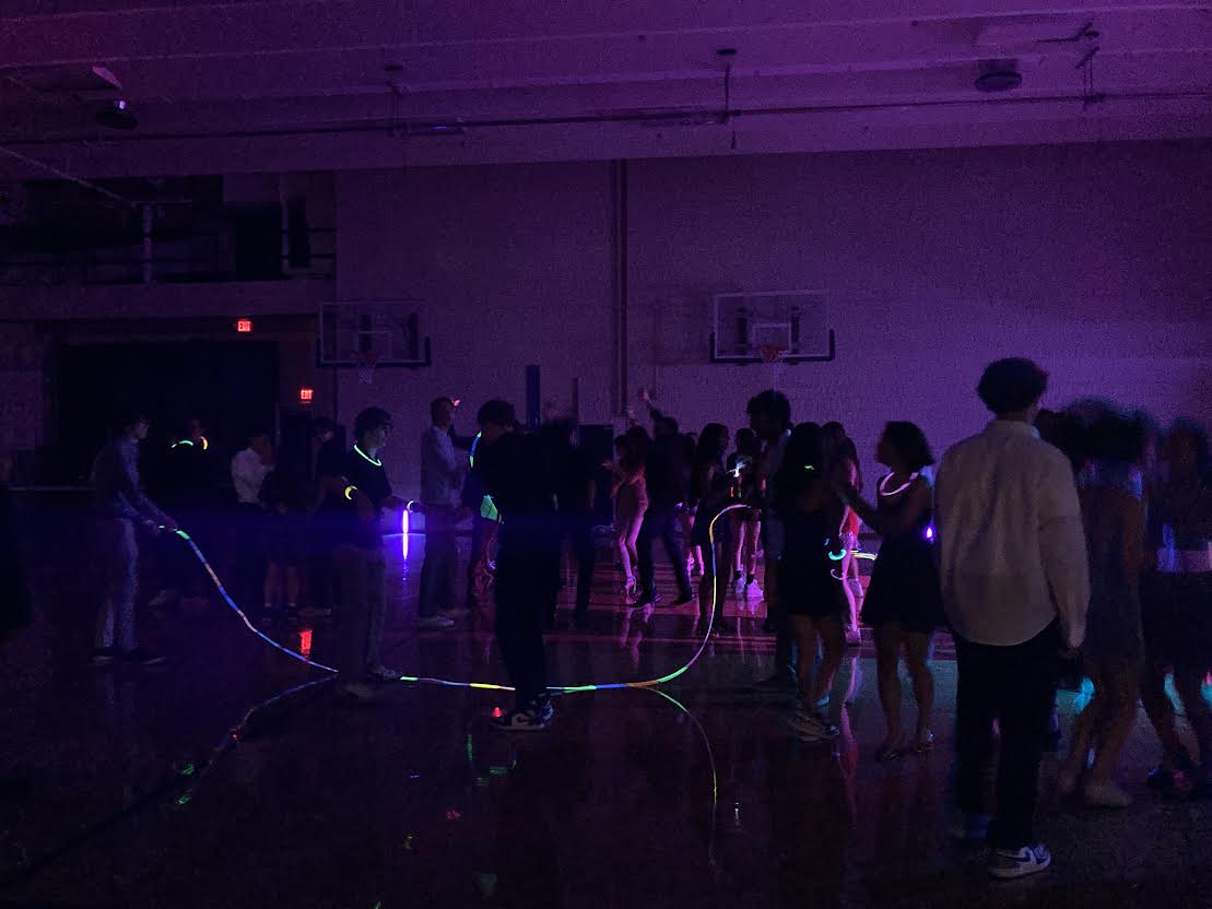 GLOW WITH THE FLOW. Seniors attempt to make a jump rope from glow sticks.