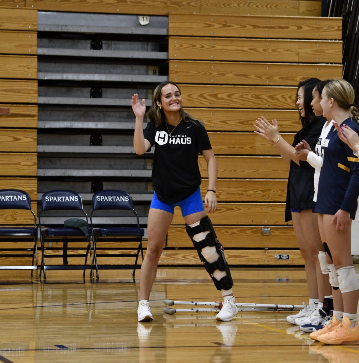 STAND AND SUPPORT. Although she is injured, Vogenthaler continues to show up at games and support her teammates.