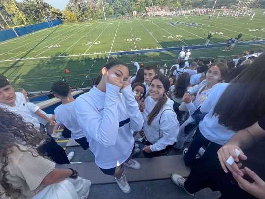 AN INTRO TO AMERICAN CULTURE. The exchange students went to a Spartans football game in their first couple of days of arriving in America. The center of the photo is Irene, she gives two thumbs up while waiting for the game to start.
