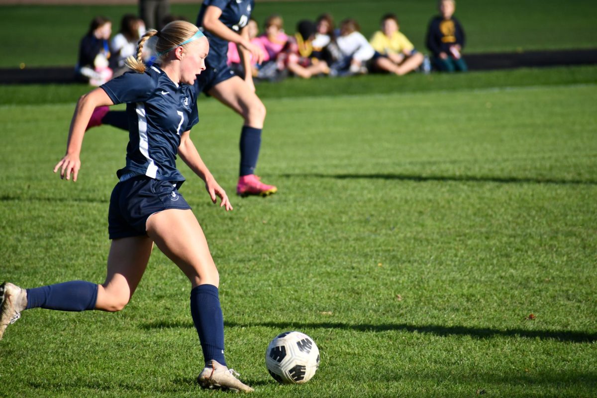 TOP SCORER.  Bollinger Danielson charges down the field preparing to shoot. “My confidence gets boosted because so many goals are scored in high school, Bollinger Danielson said of the difference between school and club-level soccer games. 