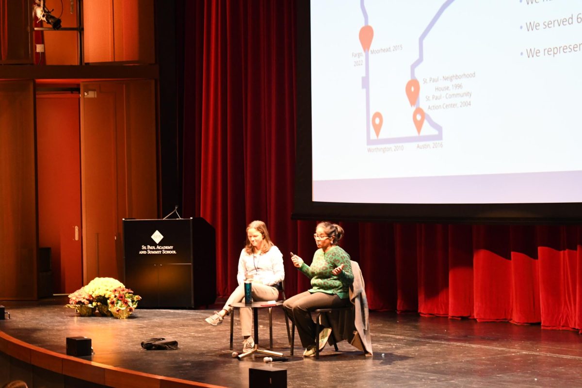 Veena Iyer, executive director of the immigration Law Center or MN, and her current  board member and SPA alum, Sarah Radosevish, speaking infront of students in the Literature of Migration and History of Refugee Communities classes.