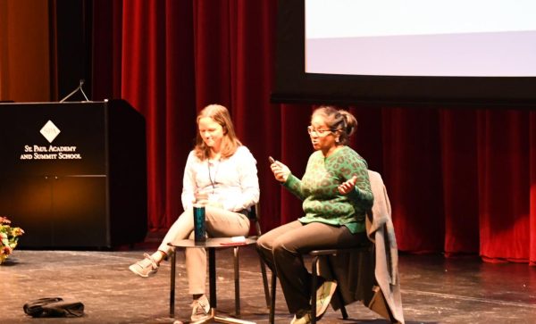 Veena Iyer, executive director of the immigration Law Center or MN, and her current  board member and SPA alum, Sarah Radosevish, speaking infront of students in the Literature of Migration and History of Refugee Communities classes.