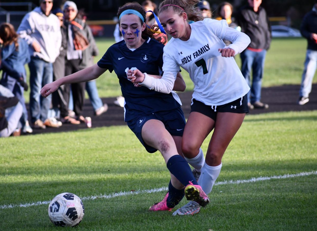 COLLISION. As sophomore Clare Ryan Bradley tries to find an opportunity to shoot, she collides with another player.