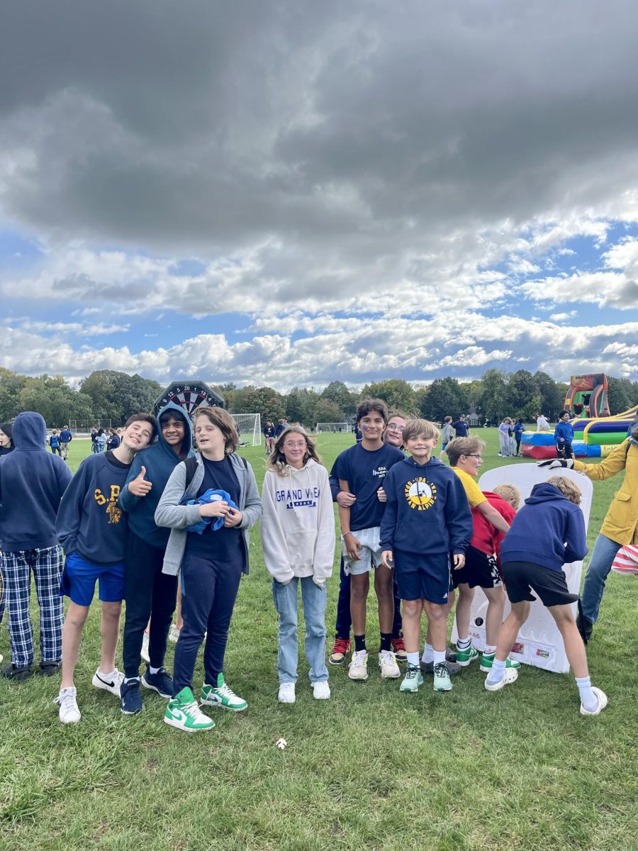 7th and 8th graders pose for a picture while they wait for carnival games. 