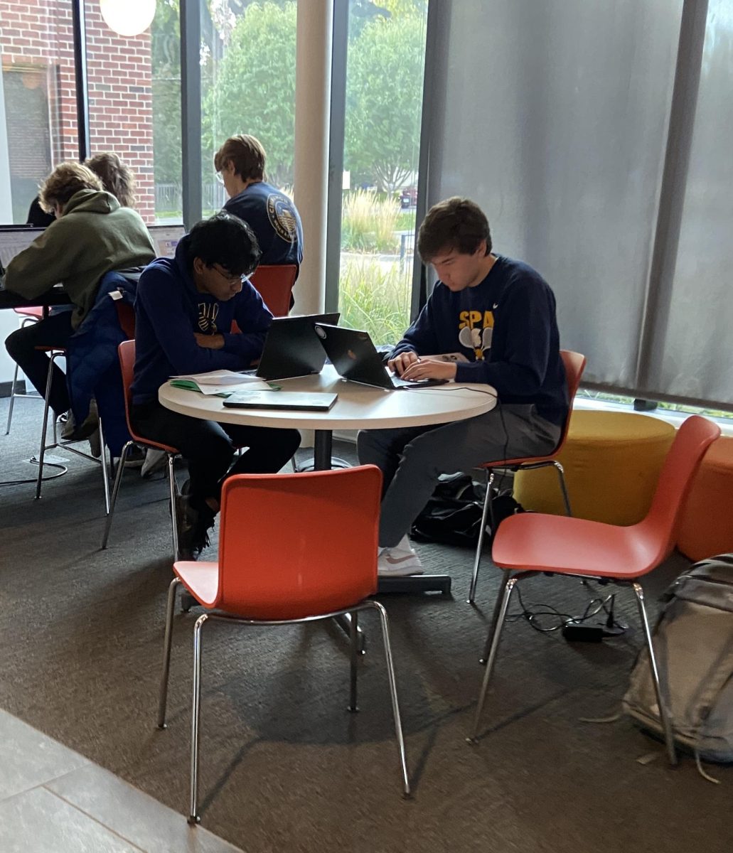 I LOVE MONDAYS. Senior Rusheek Kolan sits in Schilling and finishes up his homework with his friend on a lovely Monday morning: “I like Mondays because I love school,” he said.