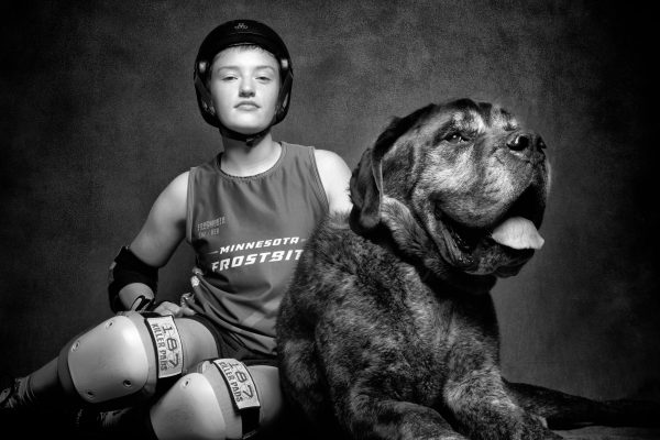 RUFF ROLLER. Elizabeth Mena-Larsen, or “Bizquik,” poses with a dog from Second Hand Hounds. In roller derby it is important to be both bark and bite. Mena-Larsen said, “I also really like the roughness of the sport.” 