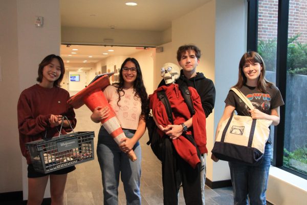 ANYTHING GOES. From left to right, Seniors Claire Kim, Melina Kannankutty, Eli Peres and Eliza Farley proudly show off their miscellaneous non-backpacks. Peres went all out, bringing a skeleton complete with clothes and its own backpack.