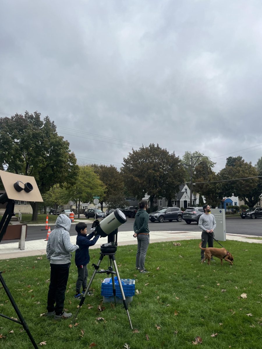 WAITING FOR THE CLOUDS TO CLEAR. Martin and students observe the sky hoping for clear weather to see the eclipse.