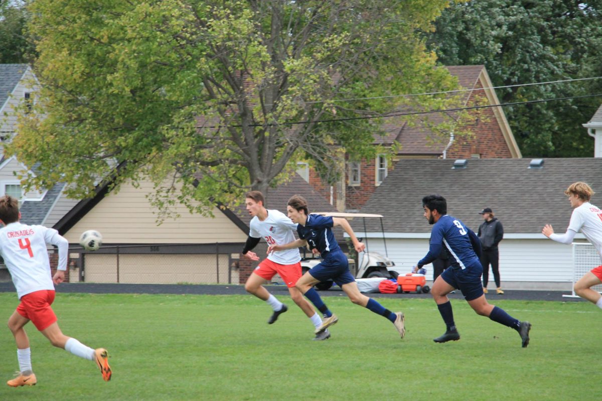 GOAL TIME. Striker Liam Sullivan runs after a ball kicked by teammate Humza Murad. Sullivan scored the first of two goals against St. Croix Lutheran.