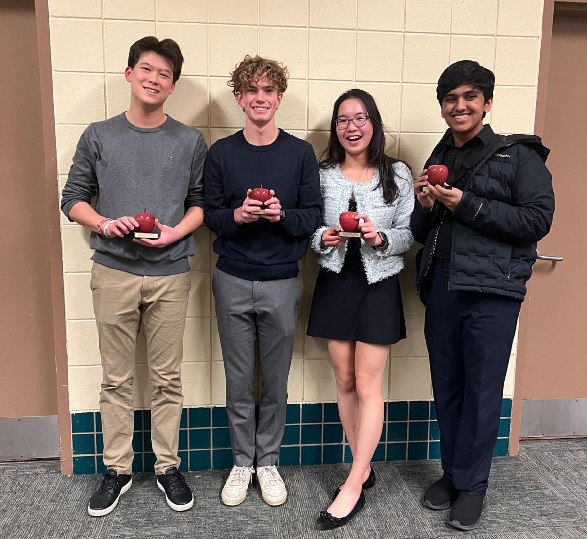 HOW ‘BOUT THEM APPLES. Debaters Henry Choi, David Schumacher, Deling Chen and Zain Kizilbash pose with their Minneapple trophies. Kizilbash had mixed feelings about the “...draining but overall worthwhile” tournament.