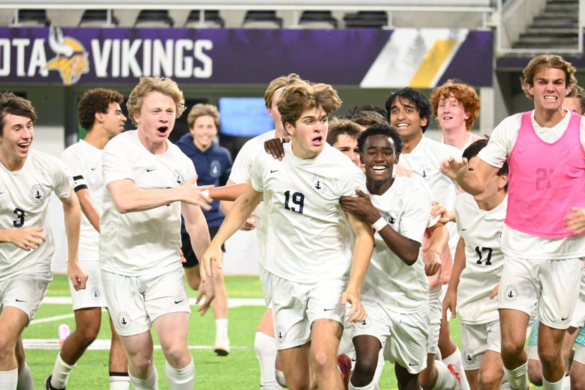 CELEBRATION. The entire team storms down the field celebrating Ethan Peltier's winning goal.