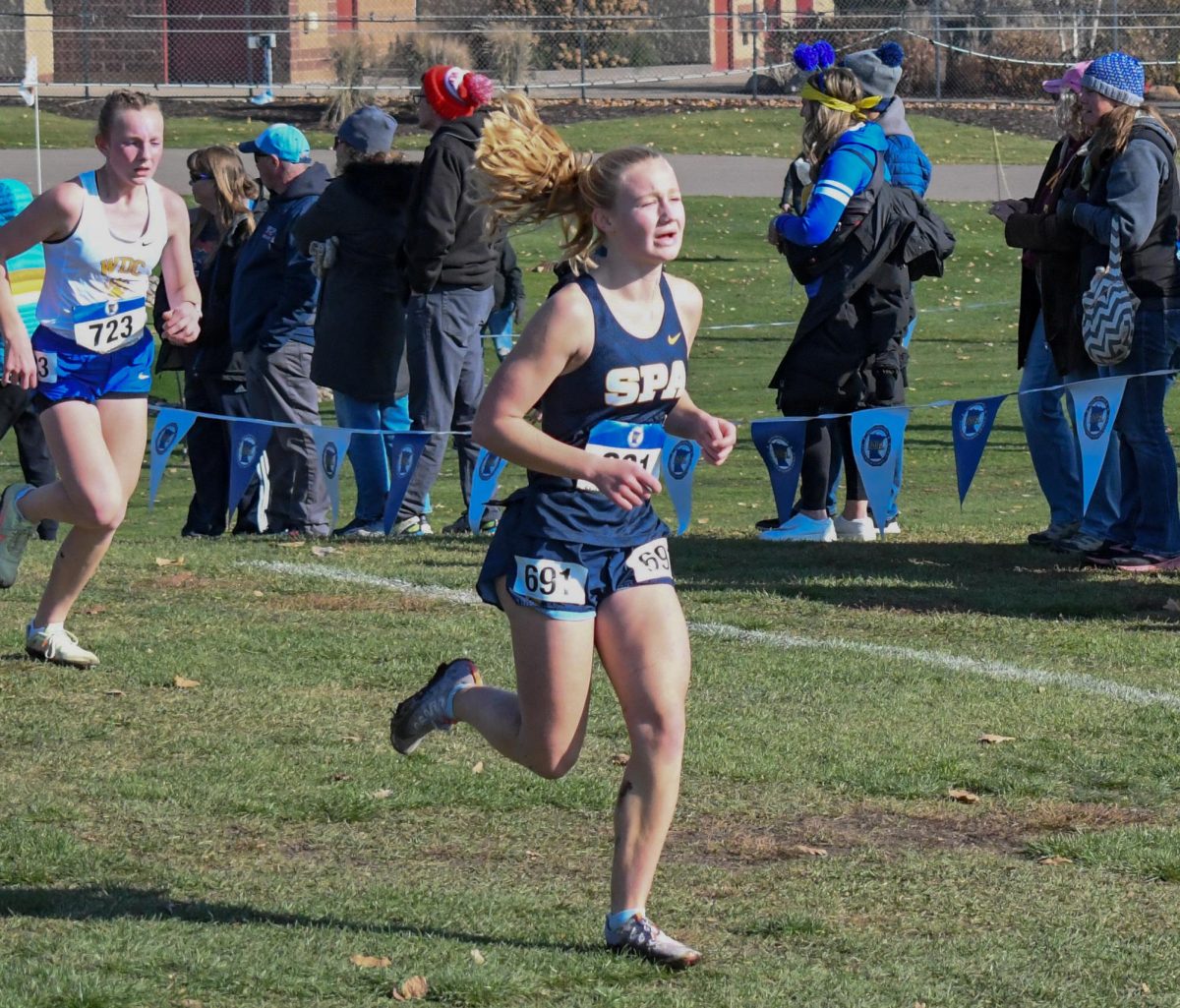 FIGHT. Feeling the burn, sophomore Maren Overgaard pushes through, making her way to the finish.
