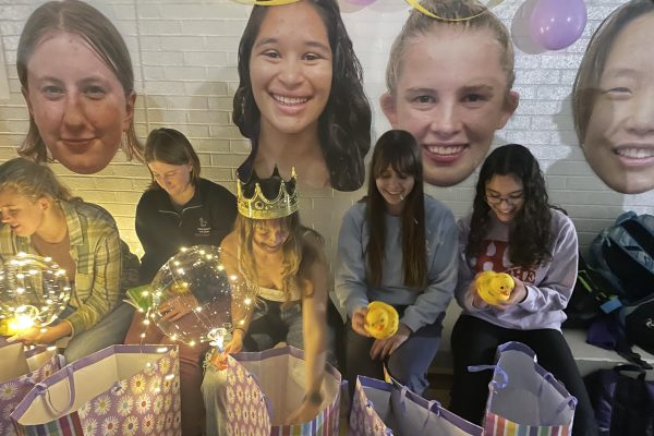 APPRECIATION. Senior Amalia Laguna opens gift bags with her fellow senior Spark swimmers.