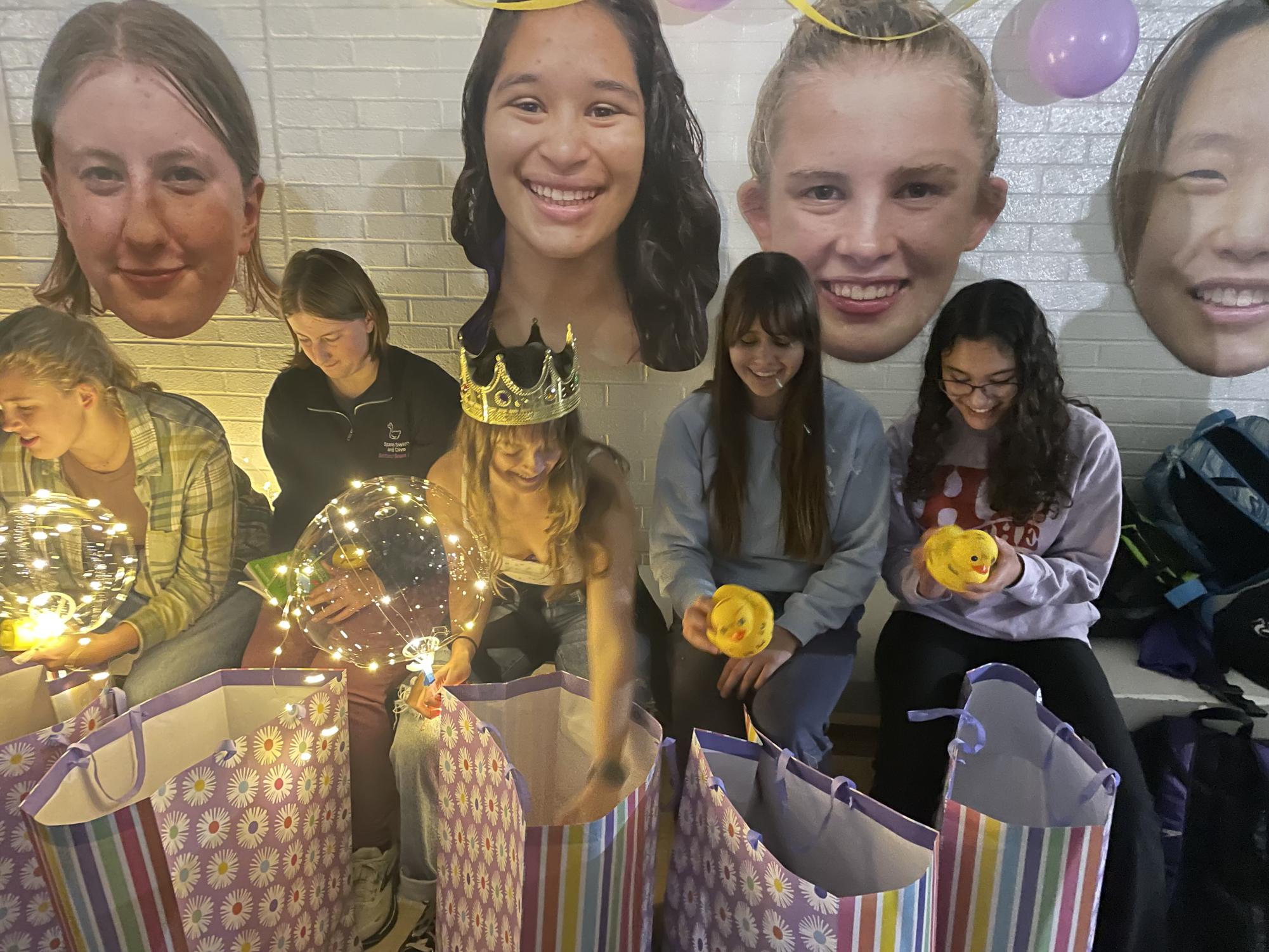 APPRECIATION. Senior Amalia Laguna opens gift bags with her fellow senior Spark swimmers.