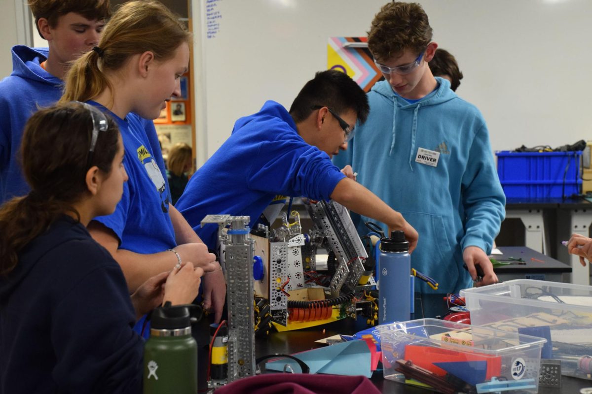 READY FOR ROBOTICS. On Nov. 10, three robotics teams from SPA competed at the league meet Center Stage on the road to qualifying for tournaments. Before competition, team members add finishing touches to their creation. Freshman Alex Haupt said, “We had to figure out how to innovate all these engineering problems and create this ramp.