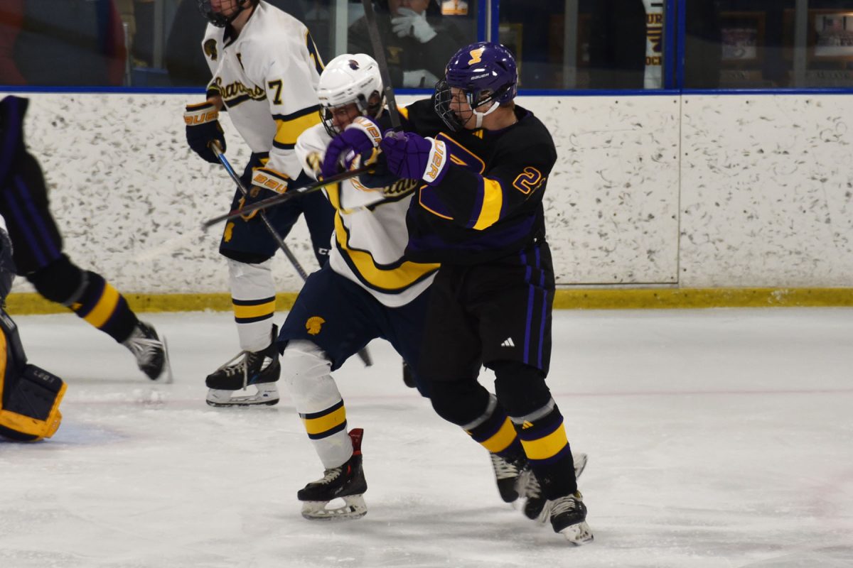 GETTING PHYSICAL. Captain Henri Peltier tries to fight off physical play from an opposing Eagle skater. 