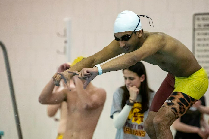 TROJAN. Senior Rishi Bhargava prepares to dive in a race from last season. For the first time this year, Bhargava became a captain of the Trojan swim team. I really want to share my passion for swimming with the rest of the team and help out by being a leader and doing my part, he said.