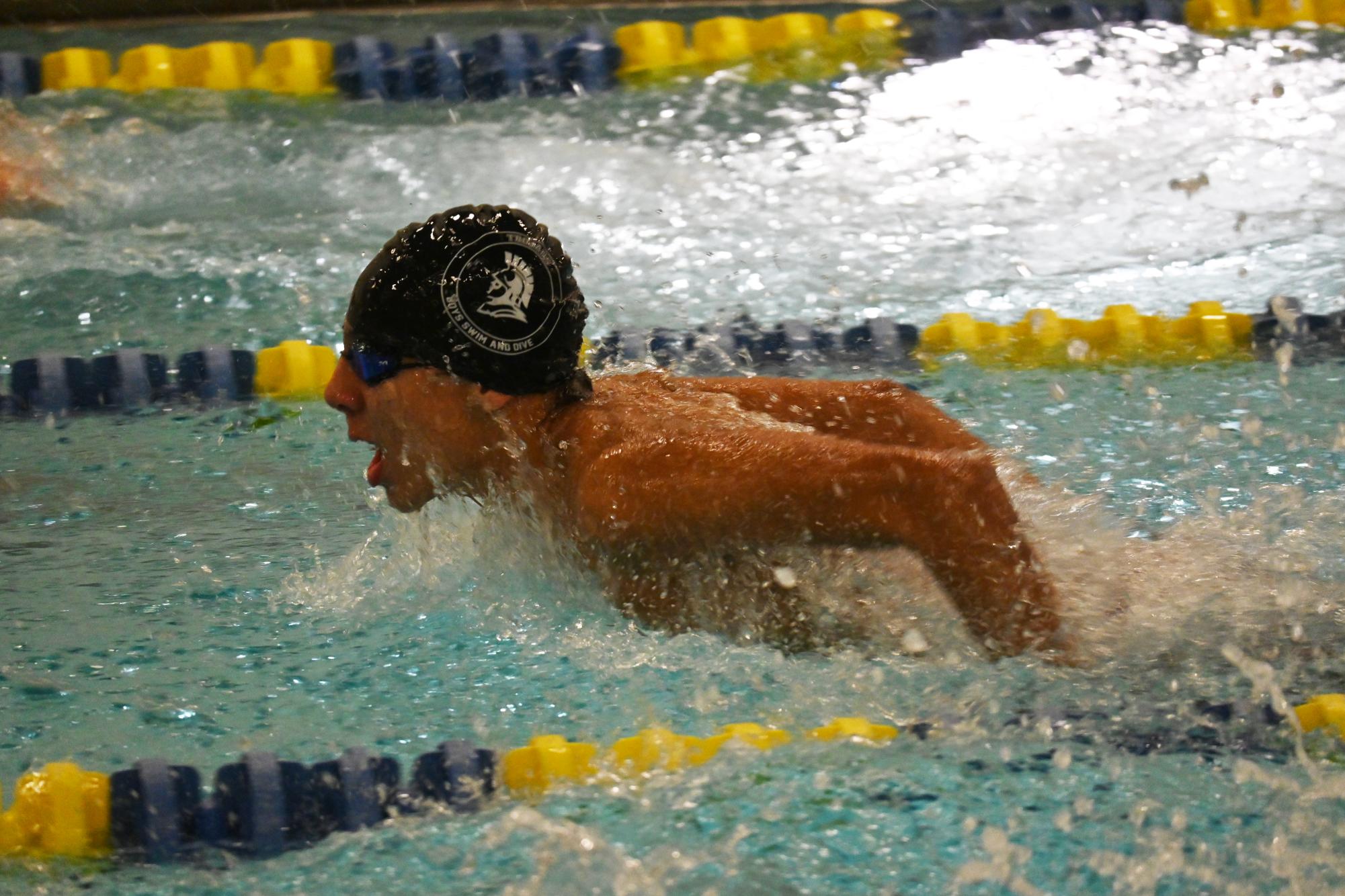 GASP OF AIR. Freshman Sam Galarneault rises up for a breath during the 100 butterfly. He placed fifth.