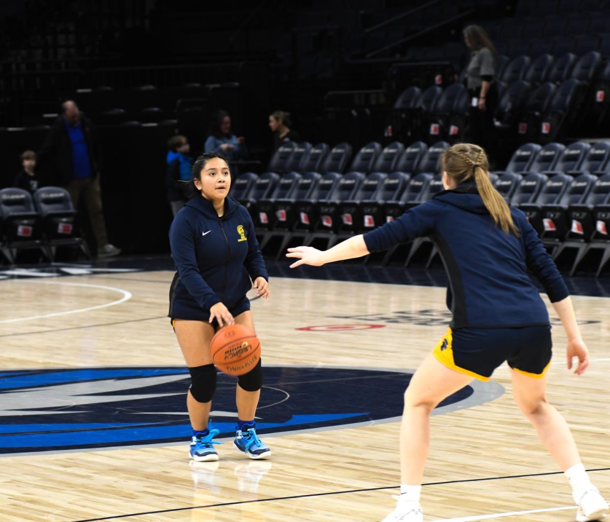 GETTING READY. Senior Naomi Kempcke, warms up with Natalie Waibel.