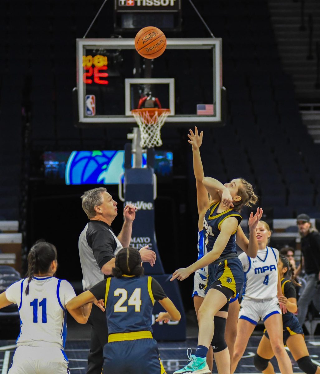 BACK IN THE GAME. Sophomore Katy Devine goes for the ball after tipoff.