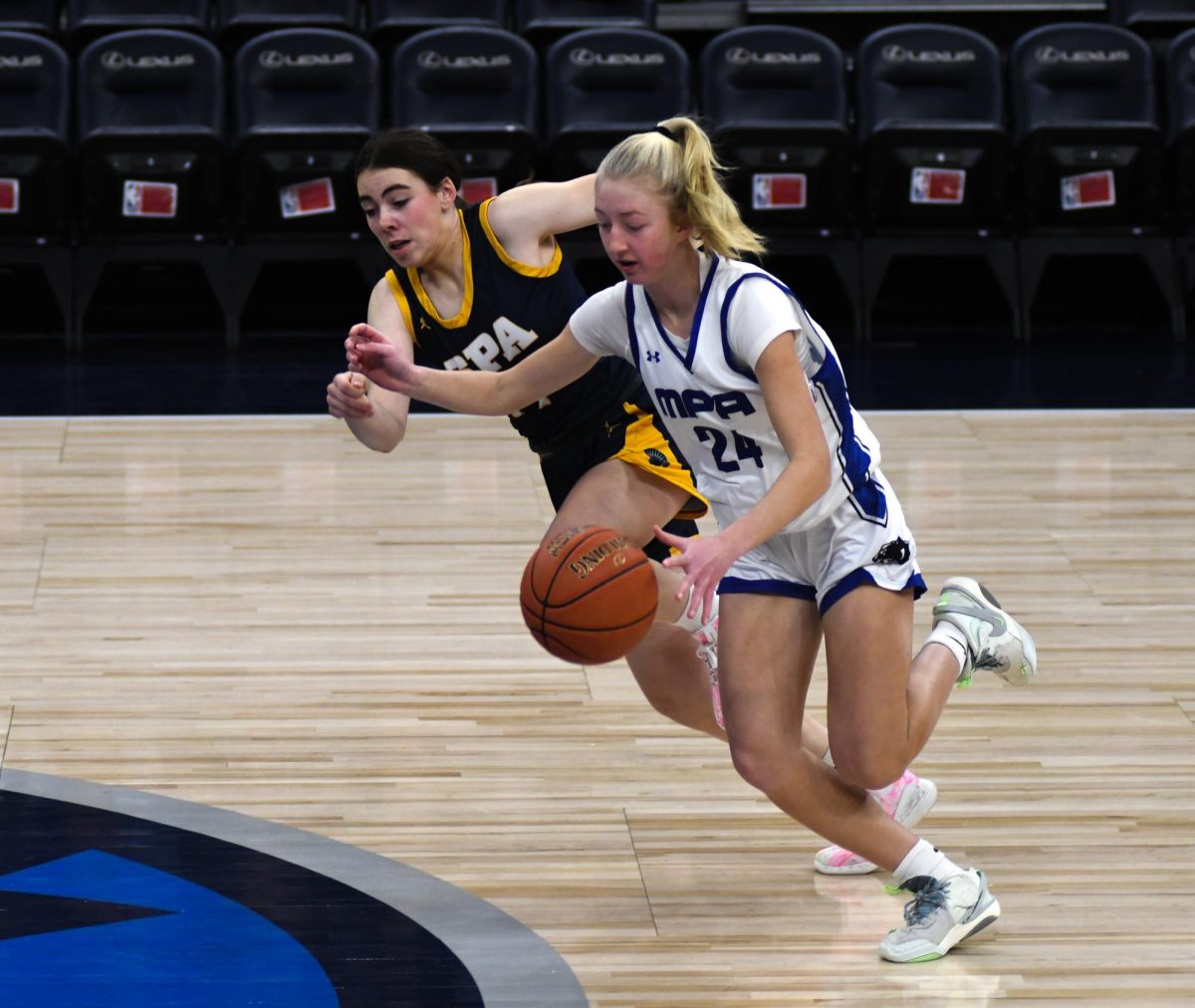 FIGHT. Sophomore Clare Ryan Bradley fights MPA player Samantha Hohn for the ball. 