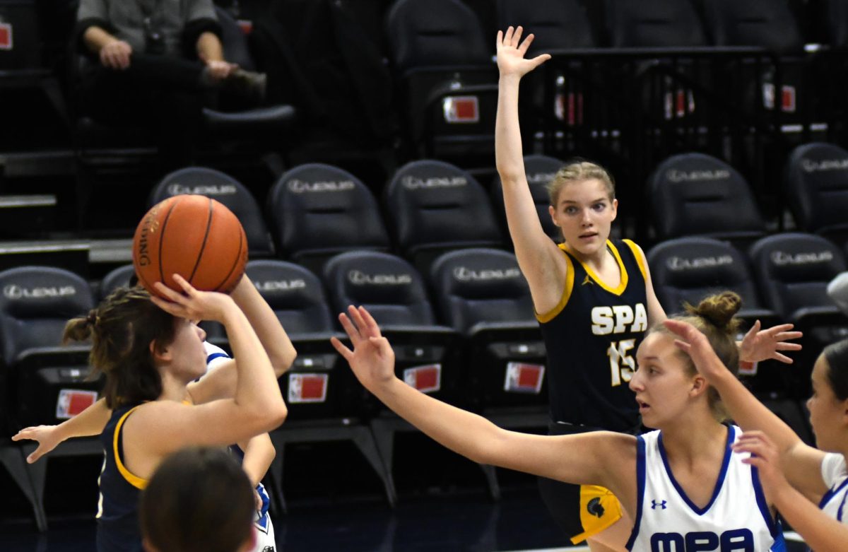 Sophomore Katy Devine passes the ball over two MPA players to Junior Natalie Waibel.