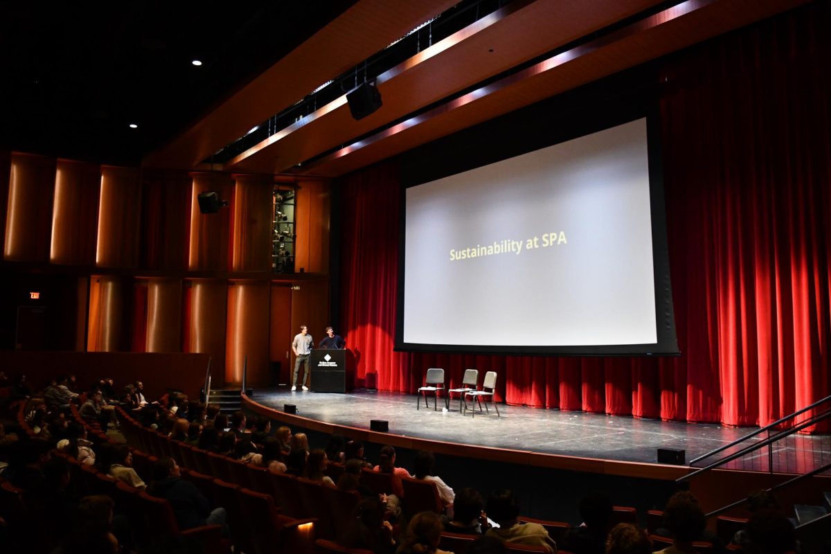 USC representatives Henry Hilton and Leo Benson prepare to present a short video on what students can do to be more sustainable.