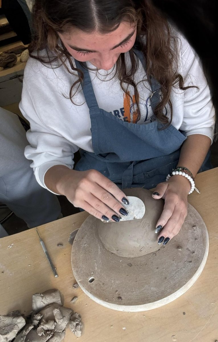 WORKING TO PERFECTION. Sophomore Lucia Gonzalez works on making her teapot in Ceramics one. 