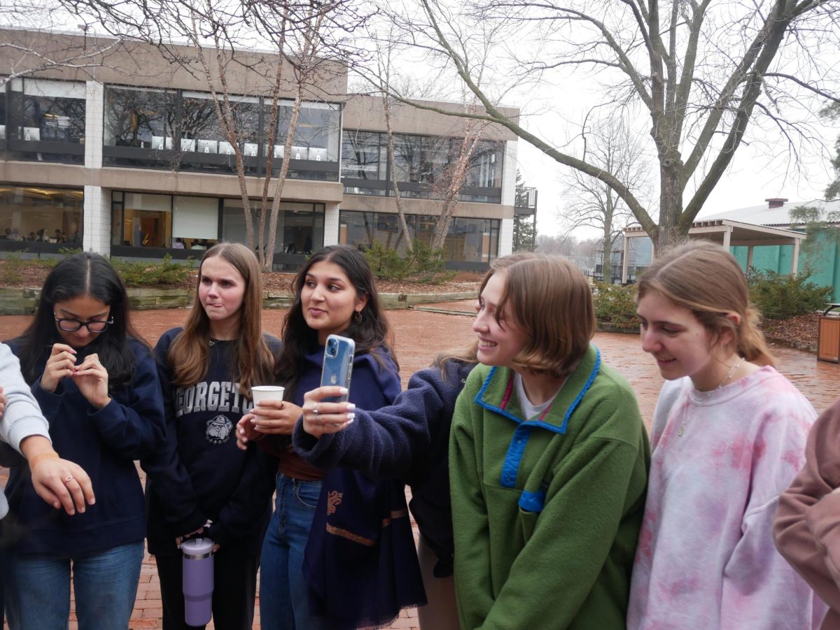 SENIOR CIRCLE. Members of the senior class gather around one of the two outdoor fire pits. Group conversation and picture-taking ensued. 