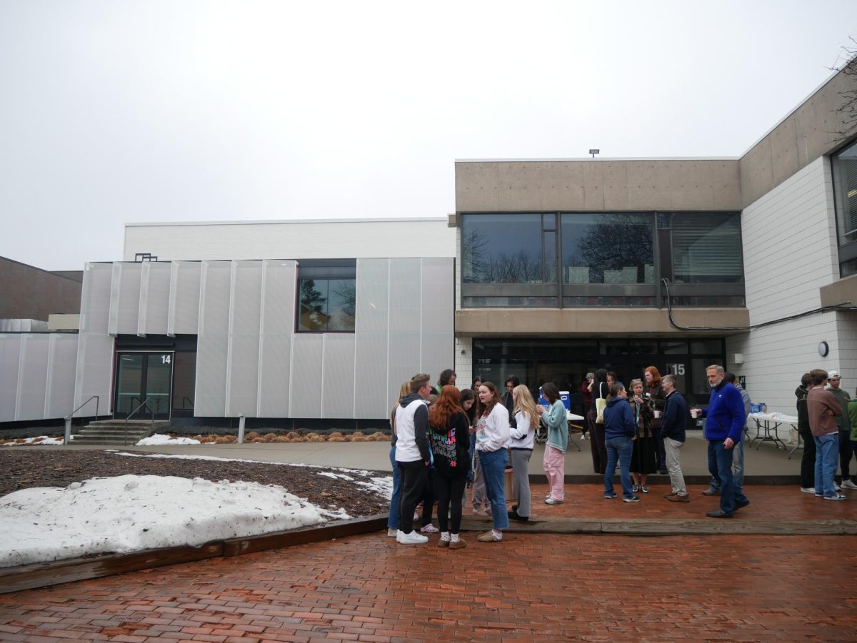 GATHER ROUND. Community members cluster around fire pits in the unusual January warmth. Students and teachers alike enjoyed some time off during the busy Community Day schedule. 