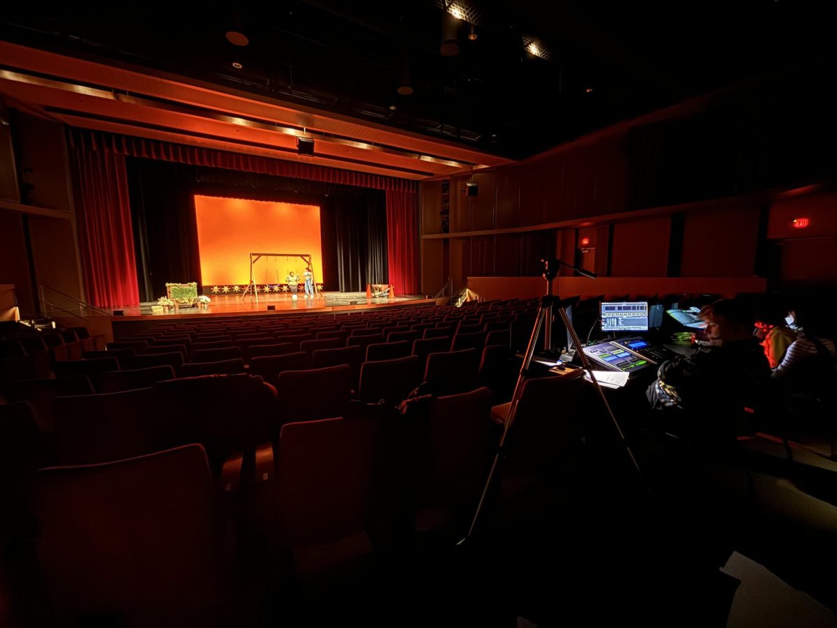 THE STAGE IS SET. Lights up and sound set, freshman Ava Doody sits at the tech table during a run through of the one-acts on Thursday night. As a member of the tech crew, she said “Youre still part of it. But you arent like out on the stage in front of like 400 people.” The competition show and two student directed one-acts will be performed Jan. 26 on the Huss Stage at 7. p.m.