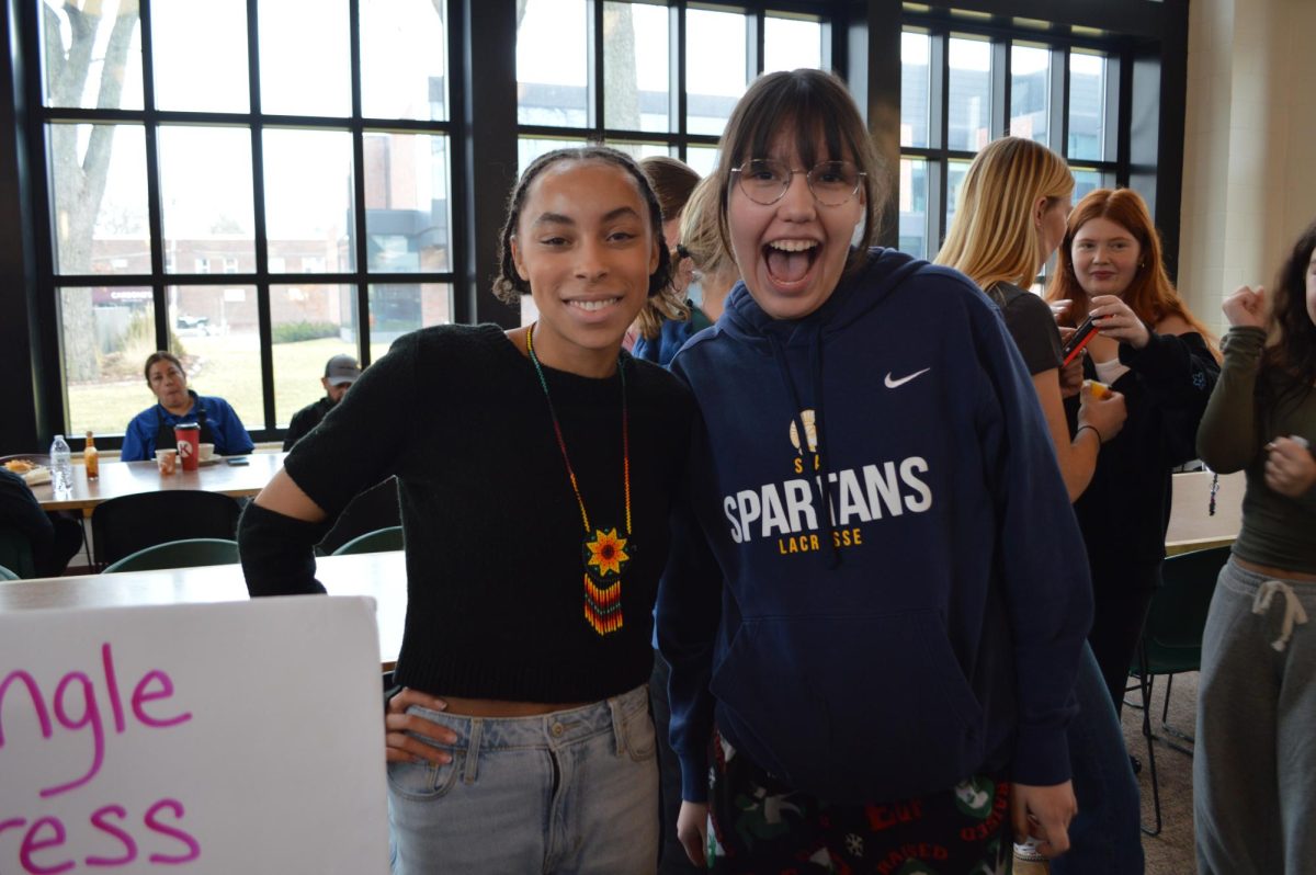 FAMILY STORIES. Junior Julia Taylor shared an important aspect of her Ojibwe culture at the Culture Fair: the jingle dress. She invited students to check out her handmade dress and read a bit about it. "I just wrote out the story of the jingle dress from what I heard from my family," Taylor said.