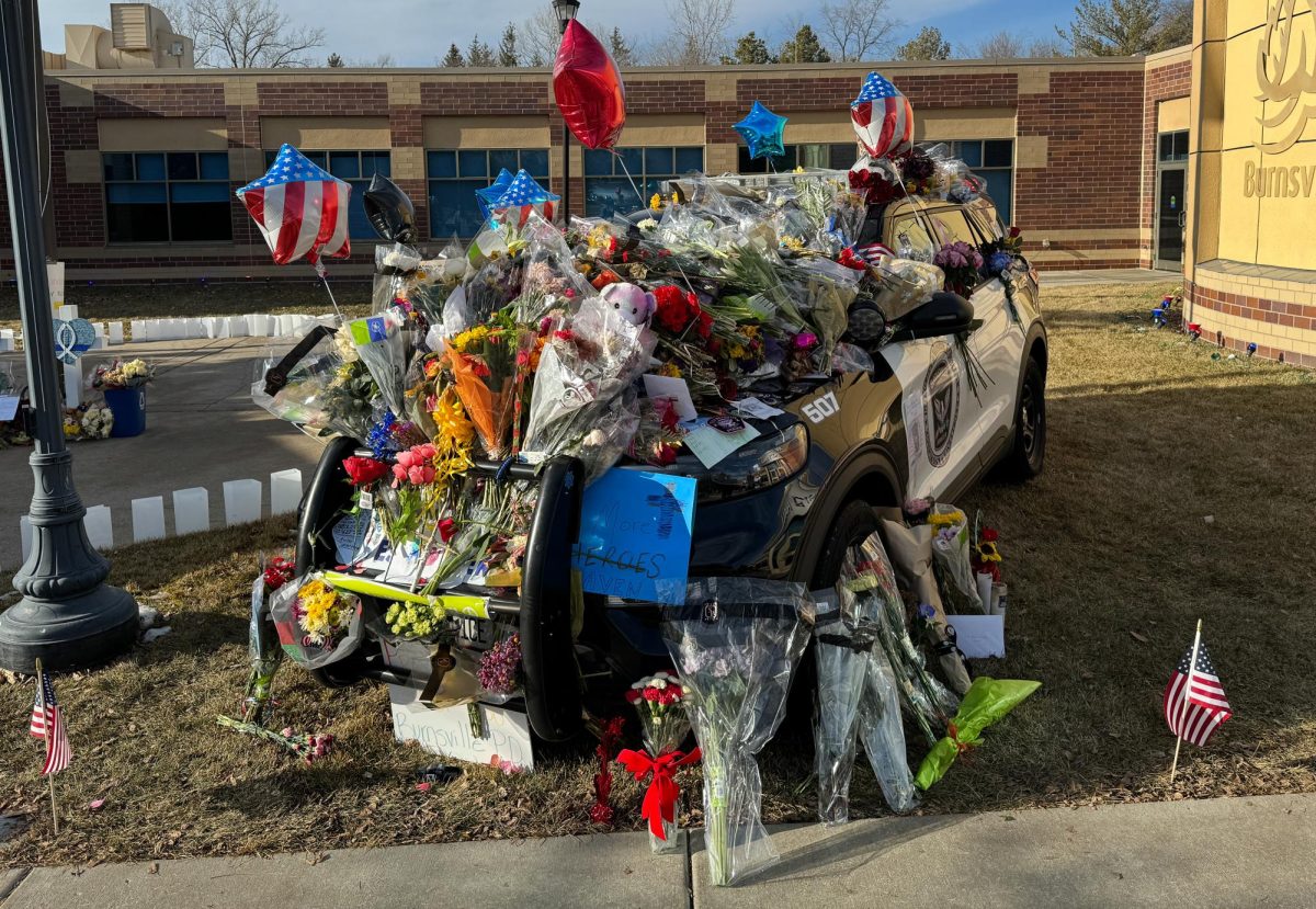 HONOR THE FALLEN. The patrol car of Burnsville PD officer Matthew Ruge, who was shot and killed after responding to a domestic situation. The car was covered in flowers and notes to the family.
