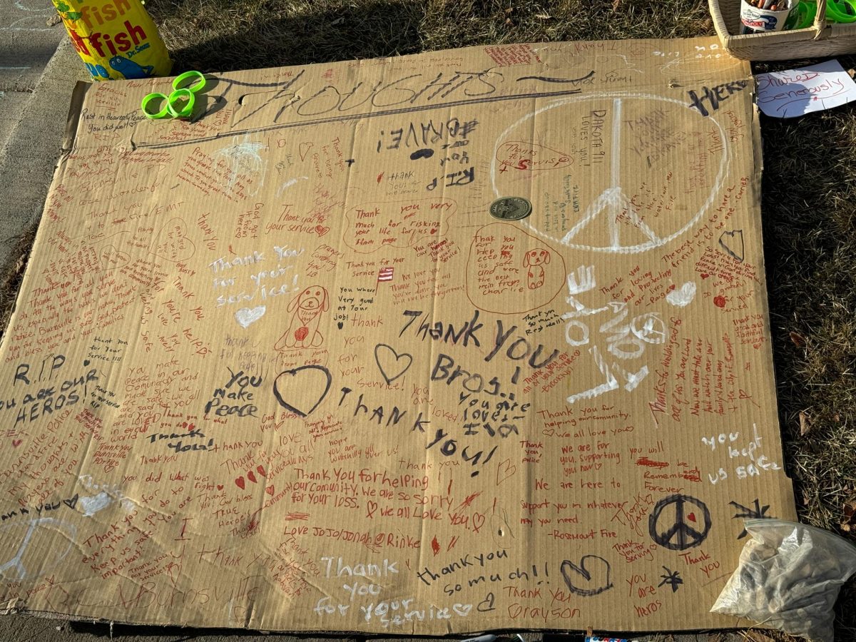 SUPPORT MESSAGES. A cardboard cutout at the memorial was covered in messages written to the fallen officers.