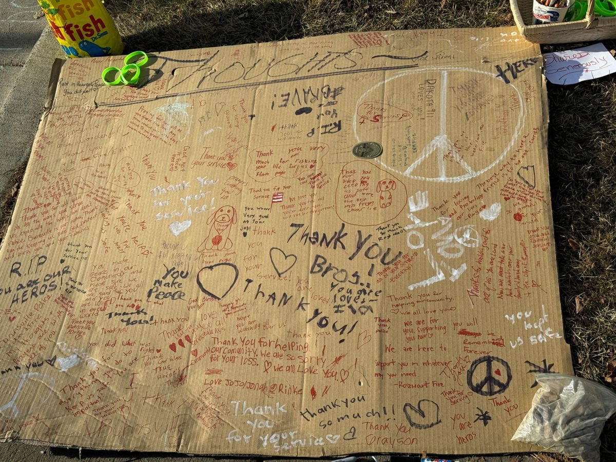 SUPPORT MESSAGES. A cardboard cutout at the memorial was covered in messages written to the fallen officers.