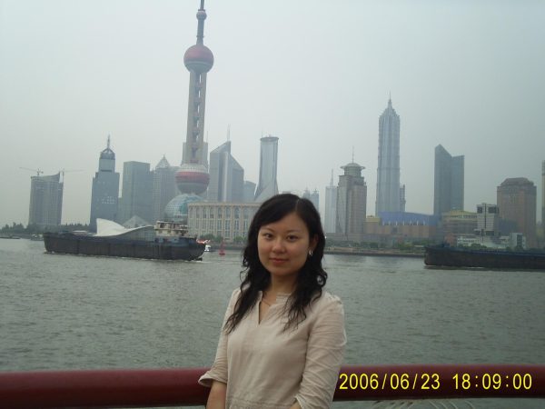 OPPORTUNIY. Tian Wang stands in front of the Shanghai skyline while on a trip for an interview with the Confucius Institute. Photo Submitted by Tian Wang.