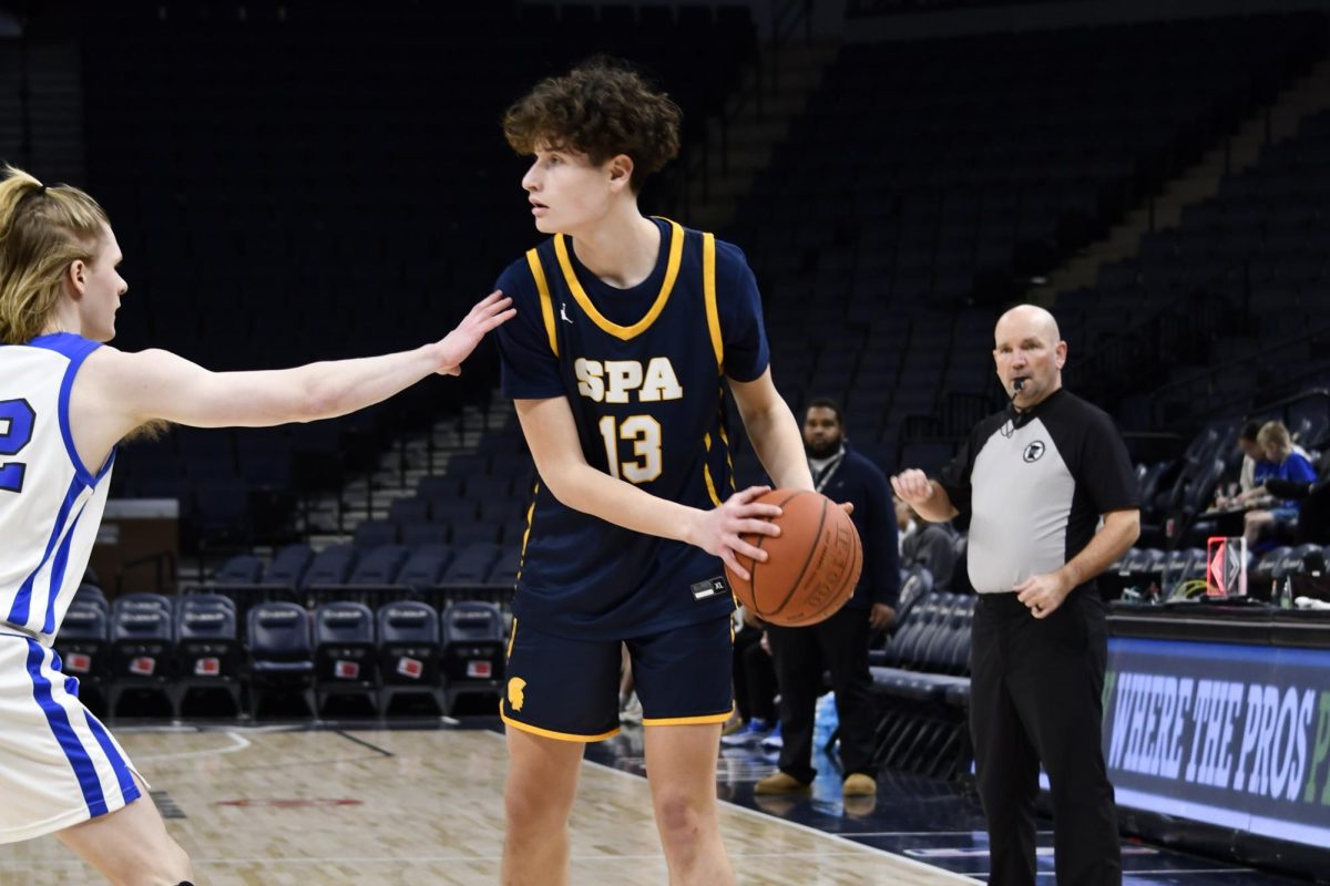 SHARP SHOOTER. Captain Mikkel Rawdon prepares to pass during a game at the Target Center. Rawdon has tallied a high number of points during his two years playing for varsity. 