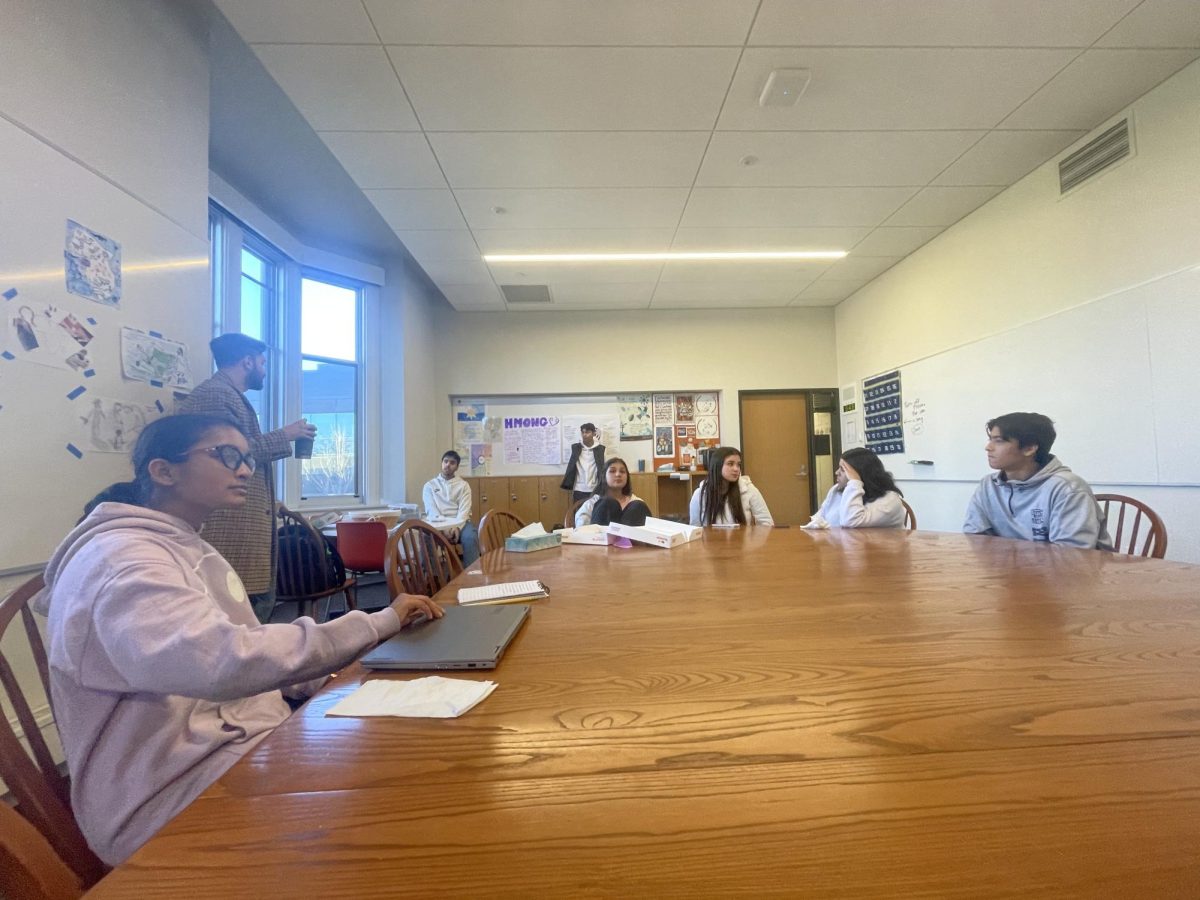 MSA TALKS CULTURE. The Muslim Student Alliance sits around the Harkness table in the World History II room as they chat about their days and discuss culture and religion together.