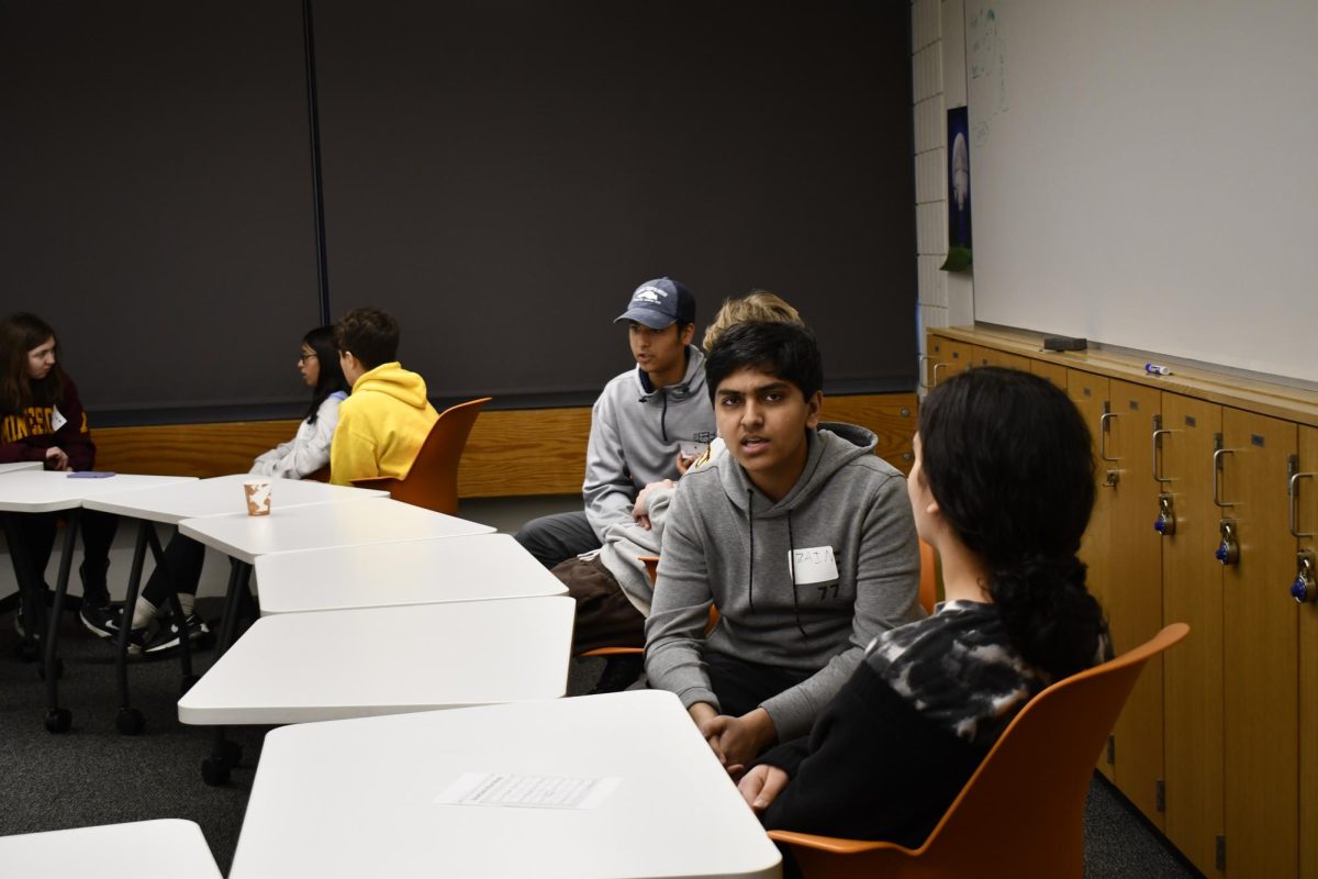 TALK IT OUT. Sophomore Zain Kizilbash and his fellow students discuss the meaning of faith in their lives during a breakout session.