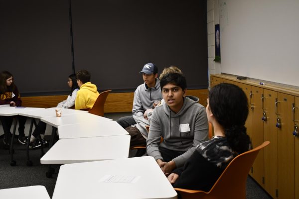 TALK IT OUT. Sophomore Zain Kizilbash and his fellow students discuss the meaning of faith in their lives during a breakout session.