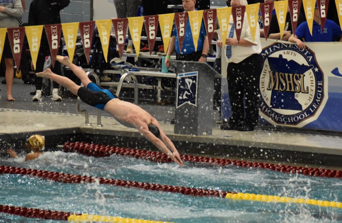 PRECISION. Highland Park junior Jon Bailey-Zimmerman enters the water for the final stretch of the race, freestyle.