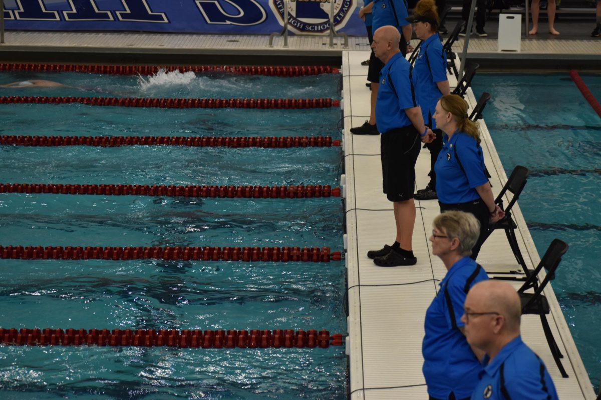 JUDGING. The MSHSL judges stand on either side of the pool, ensuring all rules are followed. Teams could be disqualified for disobeying the guidlines, such as false starting.