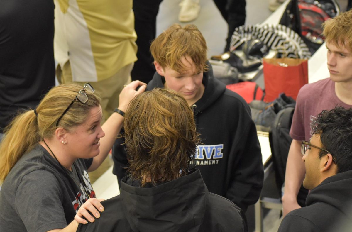 ENCOURAGMENT. Head coach Stacy Overgaard gives the four swimmers a pep talk before the competition.