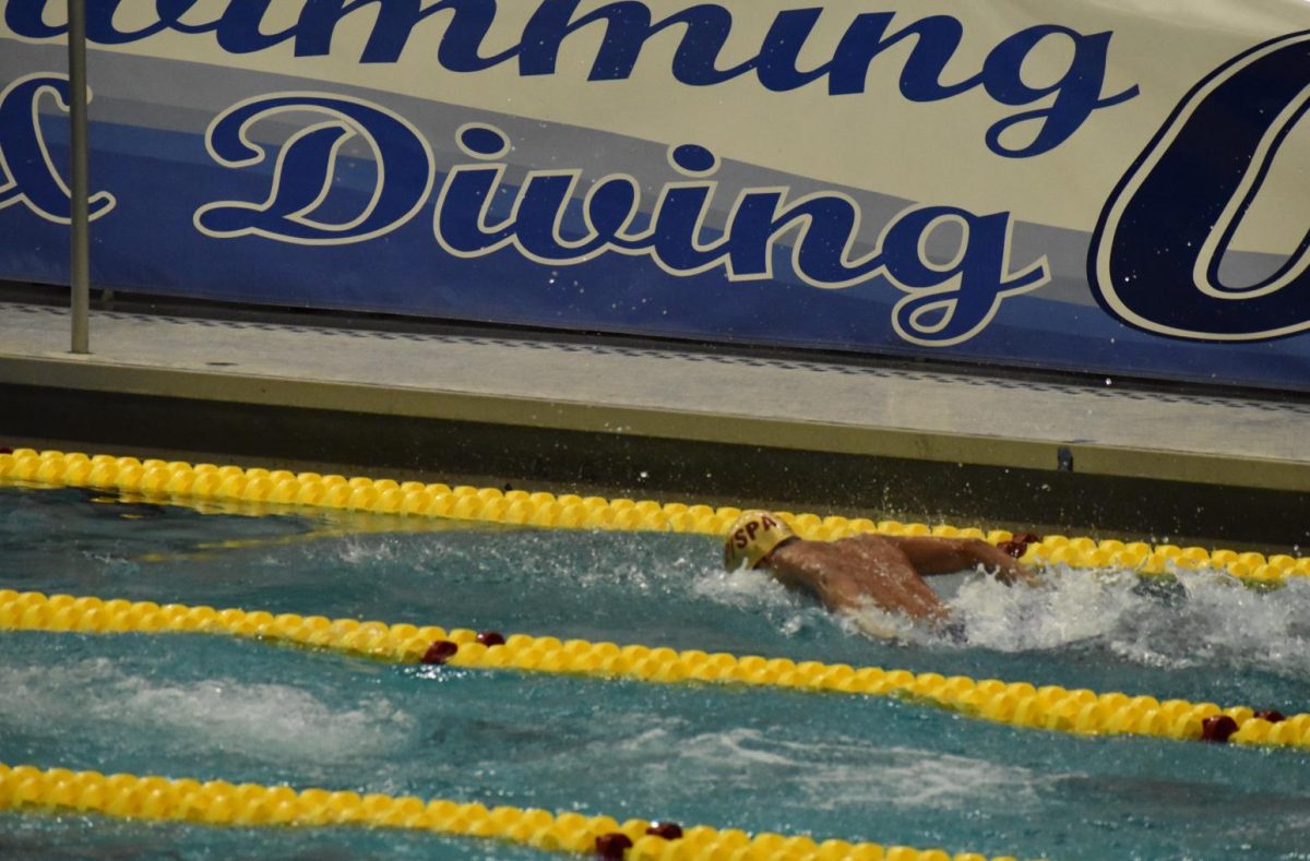 FLY. Senior Rishi Bhargava swims toward the starting board during his butterfly, the third leg of the relay.